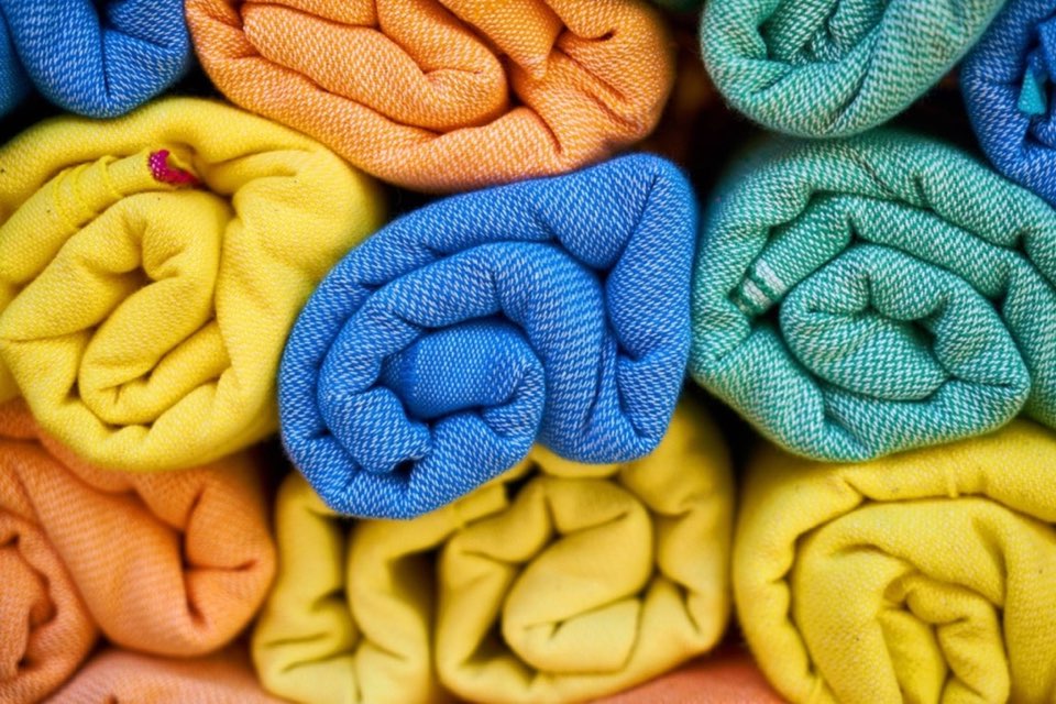 Rolled-up blankets in bright colors, stacked together